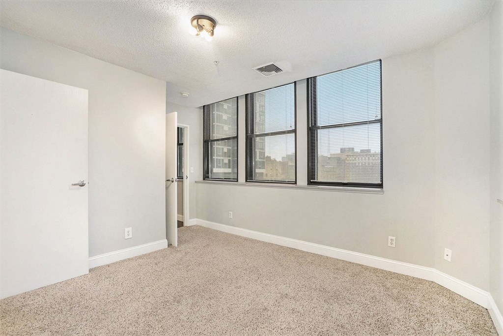 The Lofts Apartments in Grand Rapids, MI Spacious bedroom with with a large window and views of Downtown Grand Rapids