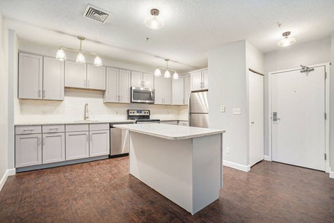 a kitchen with white cabinets and an island
