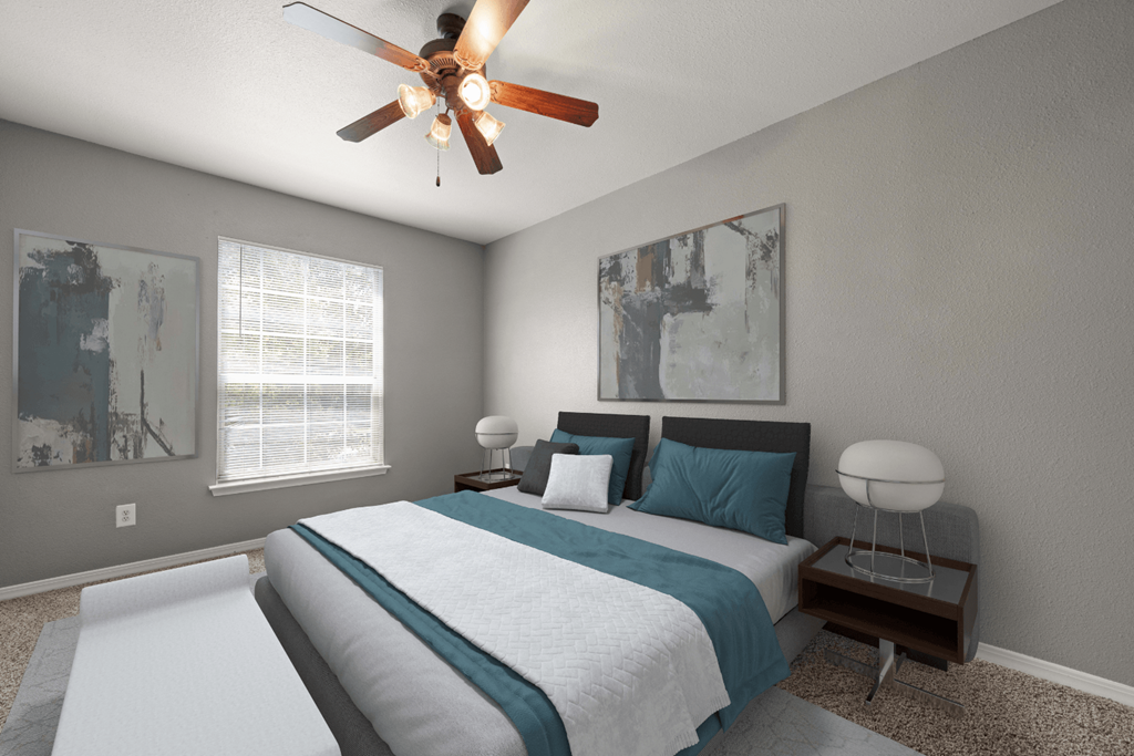 a bedroom with a large bed and a ceiling fan