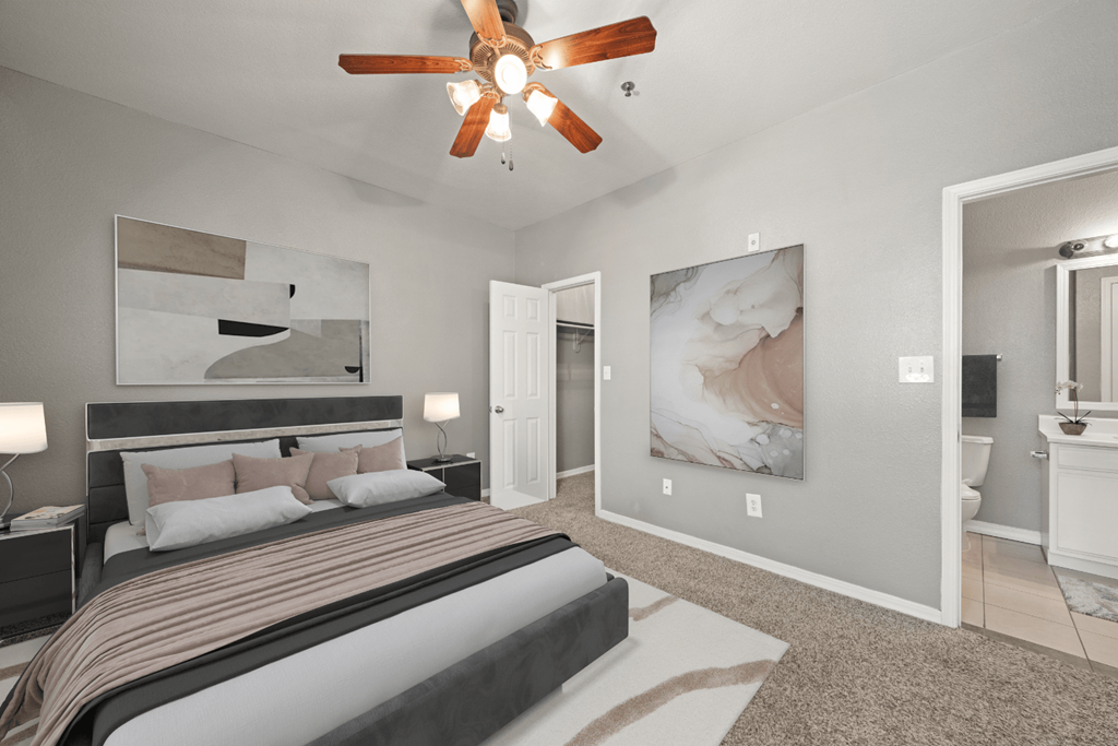 a bedroom with a bed and a ceiling fan