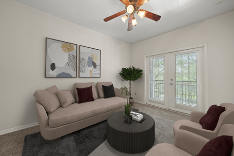 a living room with a couch and a coffee table and a ceiling fan