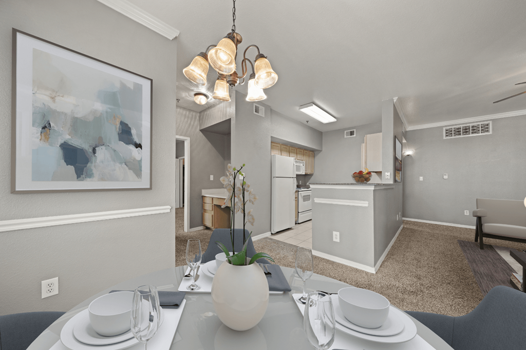 a dining room with a table and chairs and a kitchen