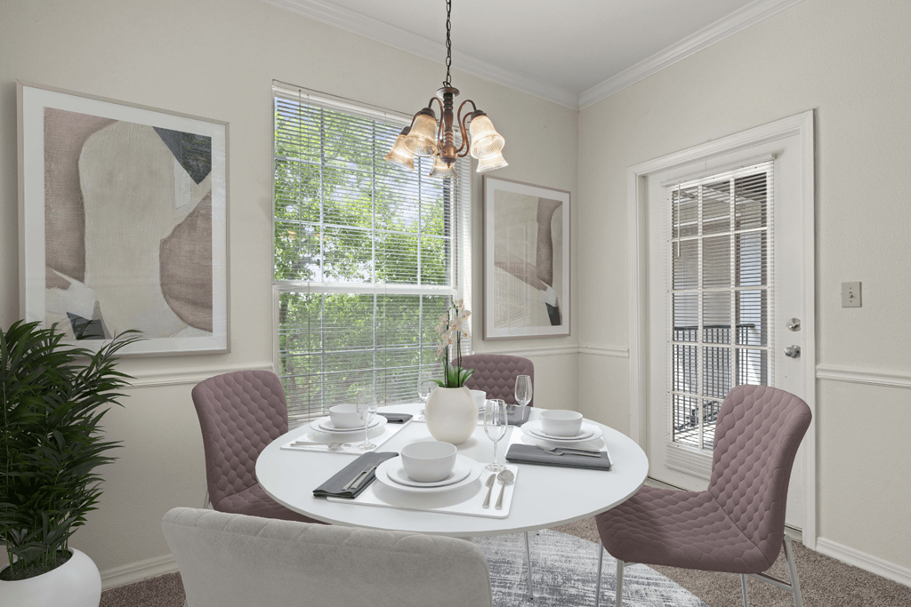 a dining room with a table and chairs and a window