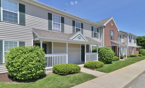 an apartment building with a sidewalk in front of it