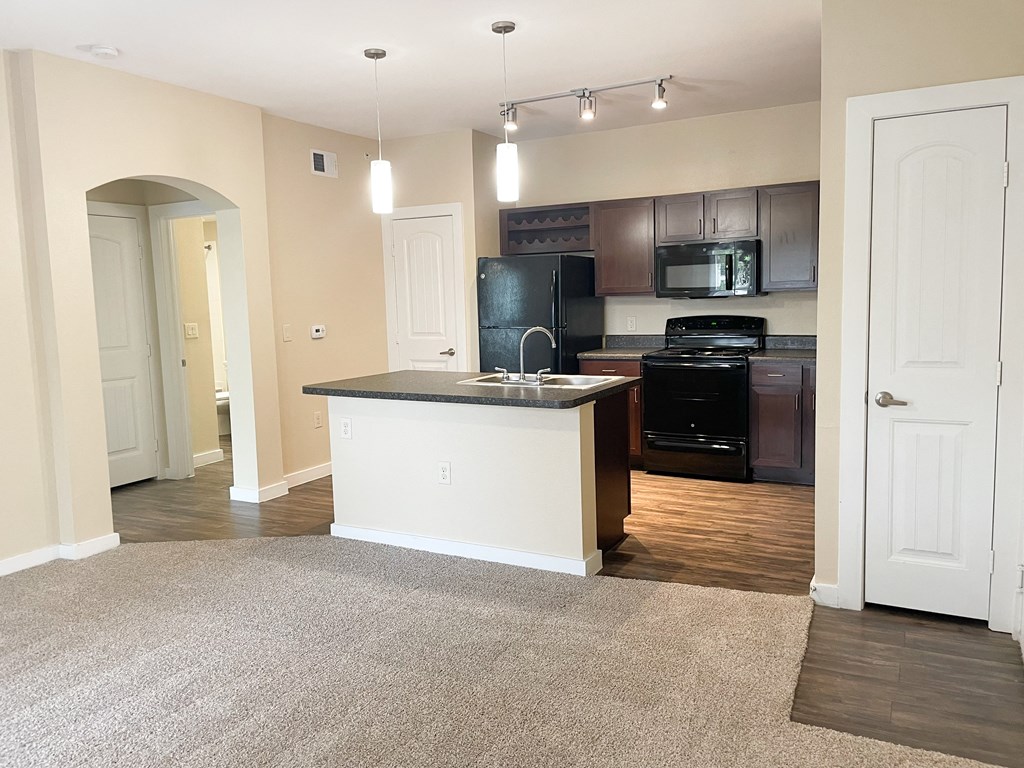 a kitchen and living room in an apartment