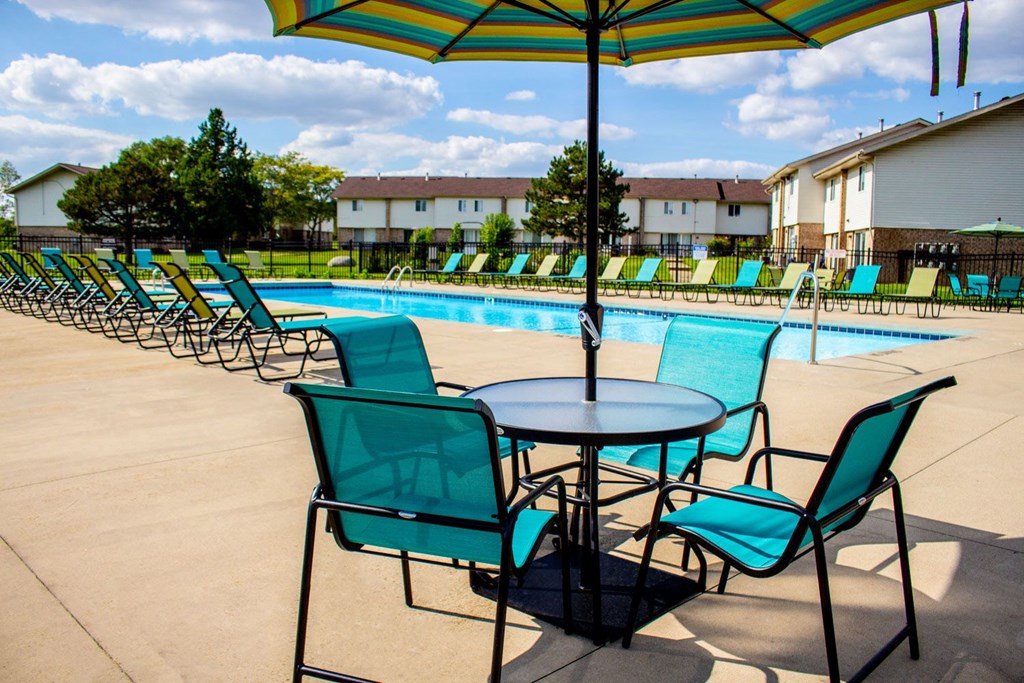 our apartments have a resort style pool with chairs and tables