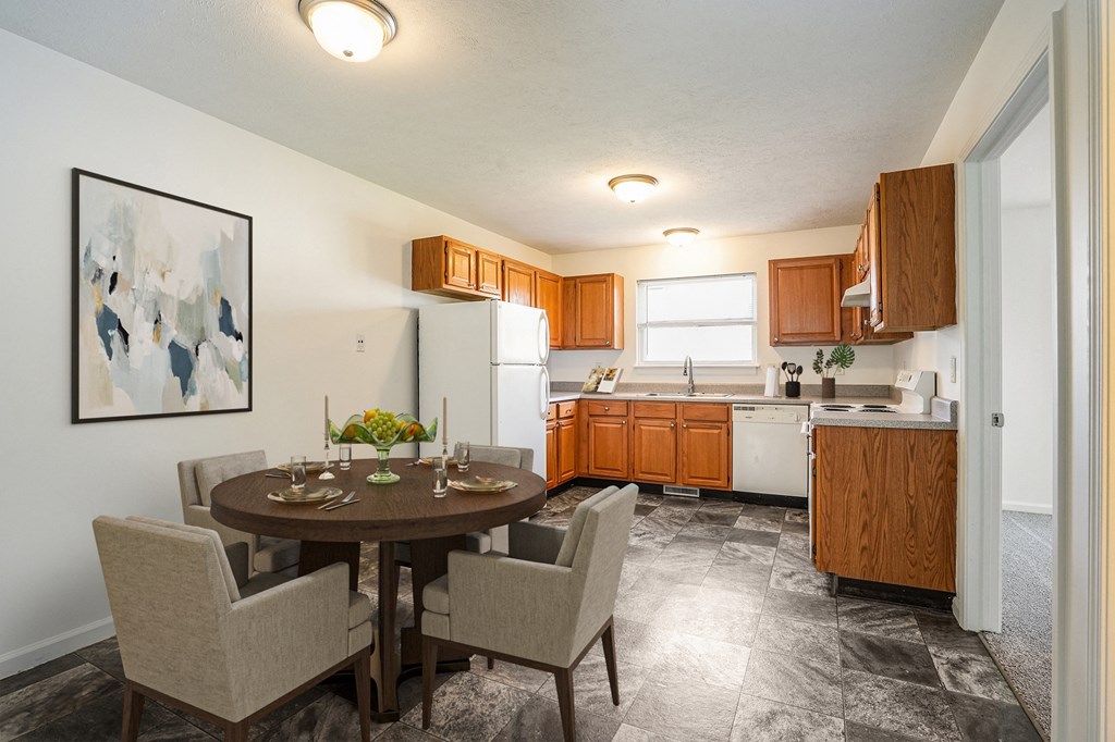 a kitchen and dining room with a table and chairs