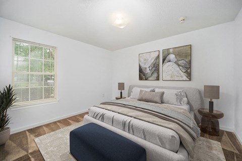 a bedroom with a bed and two paintings on the wall
