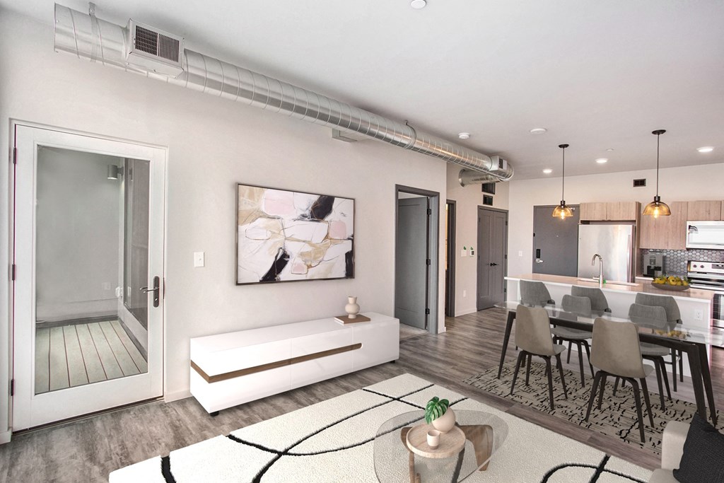 a living room with a couch and a table with chairs