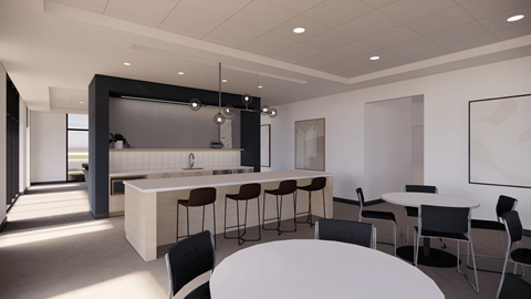 A modern kitchen with a bar area and dining table.