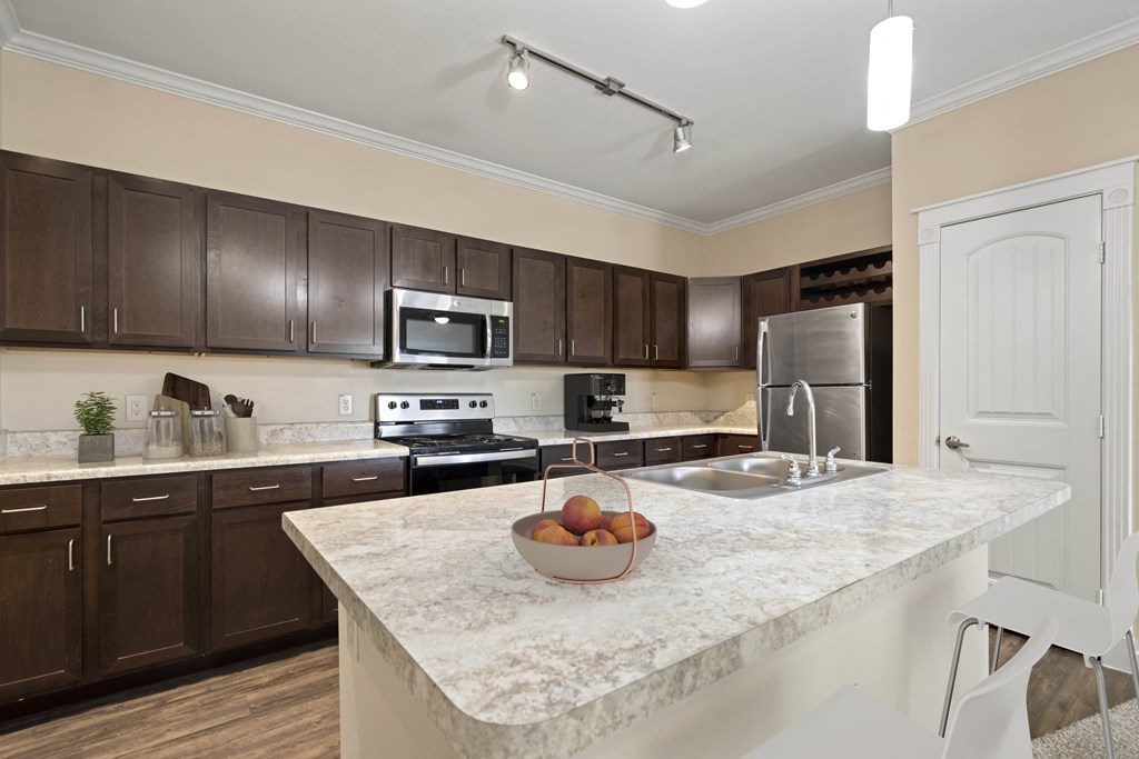 a kitchen with a marble counter top and a sink
