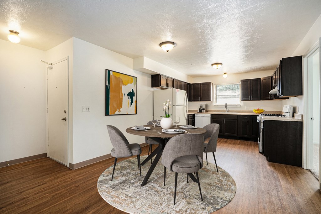 an open kitchen and dining room with a table and chairs