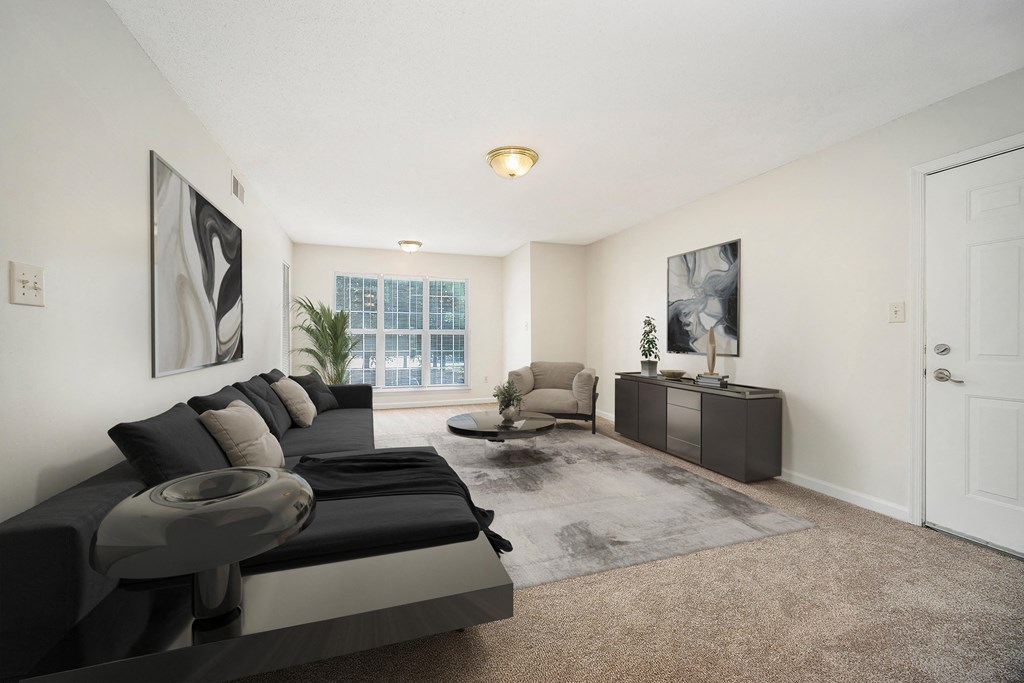 the living room of an apartment with a couch and a table