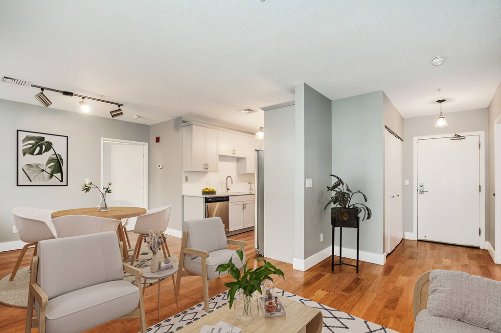 A living room with a dining table and chairs.