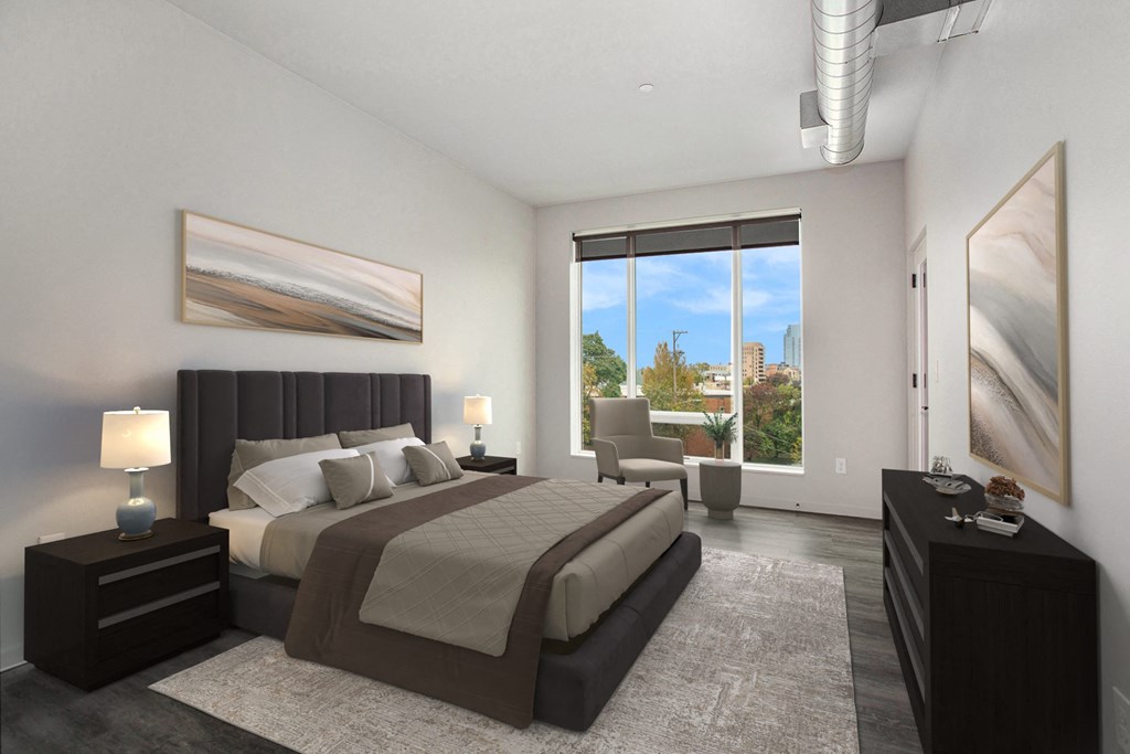 a bedroom with a bed and a large window