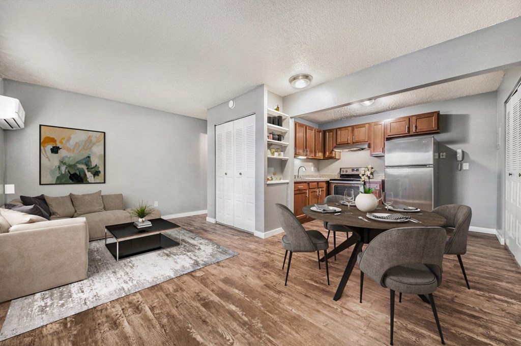 a living room and dining room with a table and chairs