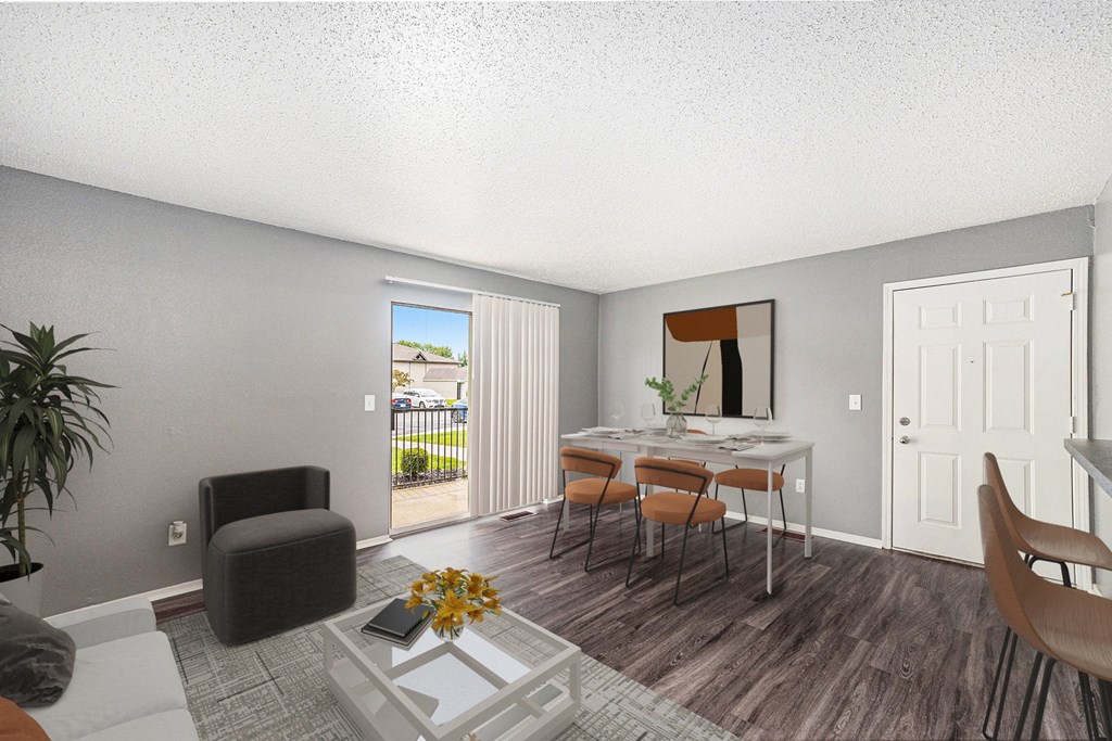 a living room and dining room with a table and chairs