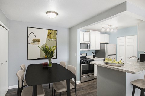 our apartments offer a kitchen and dining area with a table