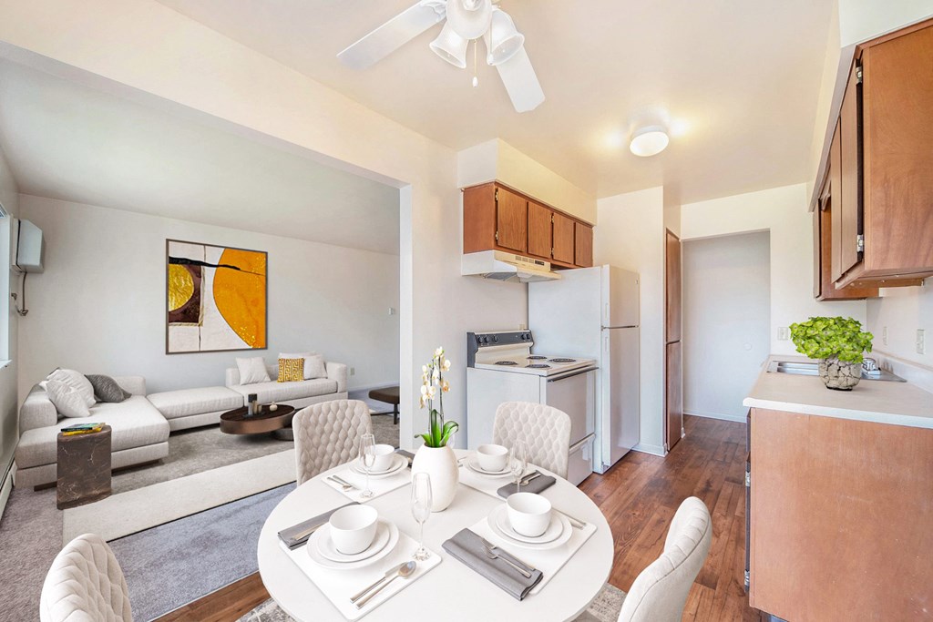 a living room and kitchen with a white table and chairs