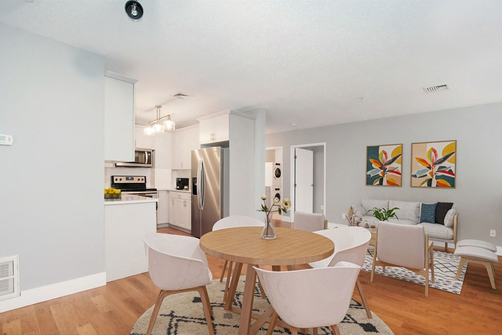 a living room and dining room with a table and chairs