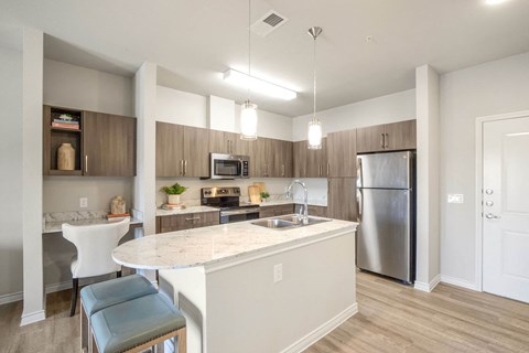 A kitchen with a white counter and a refrigerator.