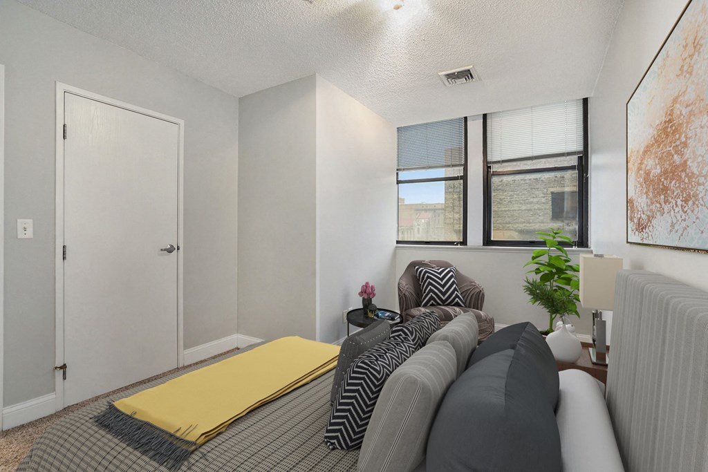 a living room with a couch and two windows