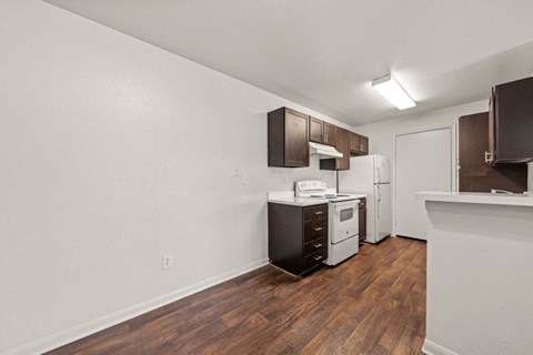 a kitchen with a stove refrigerator and a sink