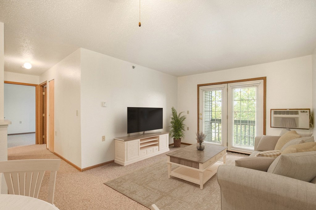 A living room with a television and a couch.