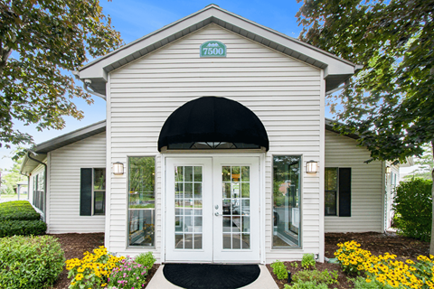a white building with a black awning
