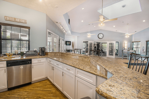 a large kitchen with granite countertops and stainless steel appliances