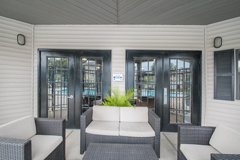 a patio with a couch and two chairs