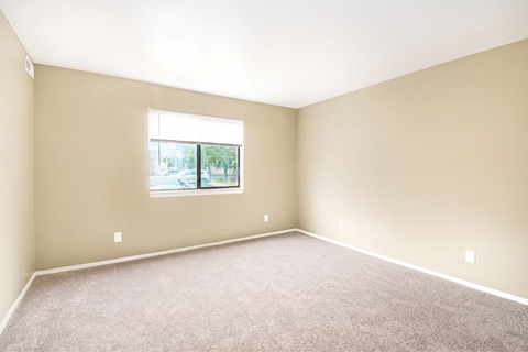 an empty bedroom with a large window