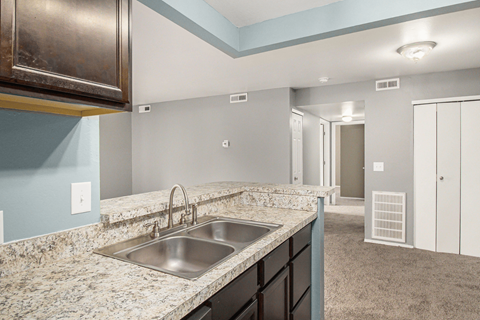 a kitchen with granite countertops and a sink