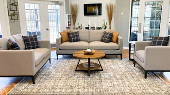 a living room with couches and chairs and a coffee table