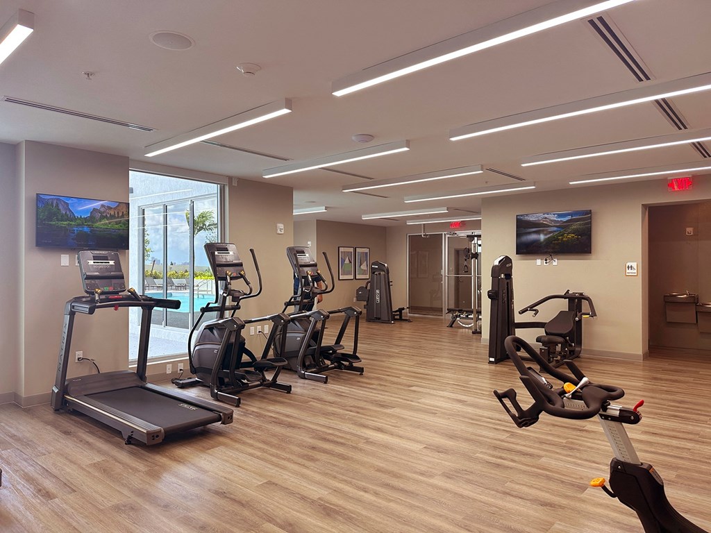 a spacious fitness center with treadmills and ellipticals  at Douglas Enclave, Miami, Florida