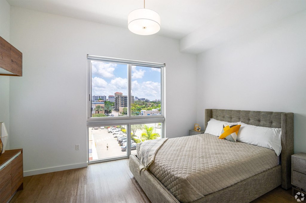Bedroom with a large bed at Douglas Enclave, Miami, FL.