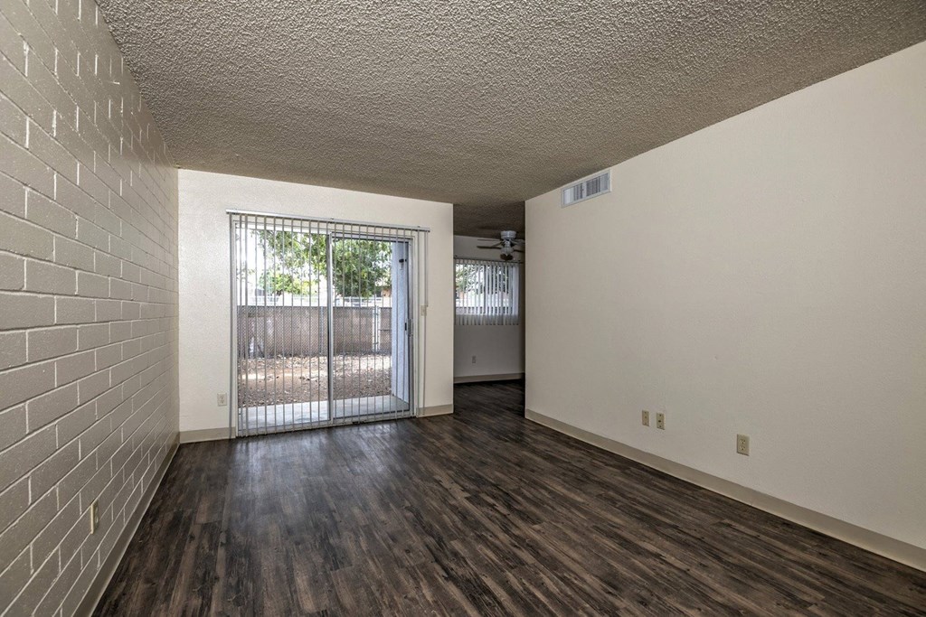 an empty living room with a sliding glass door
