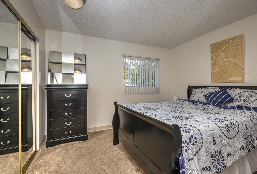 a bedroom with a bed and a dresser