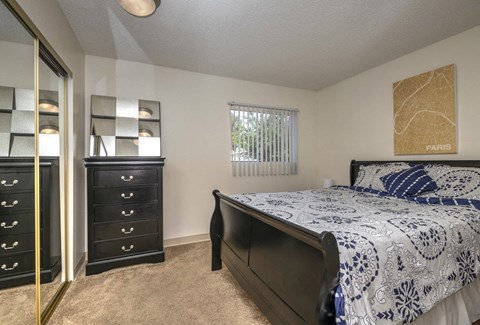 a bedroom with a bed and a dresser