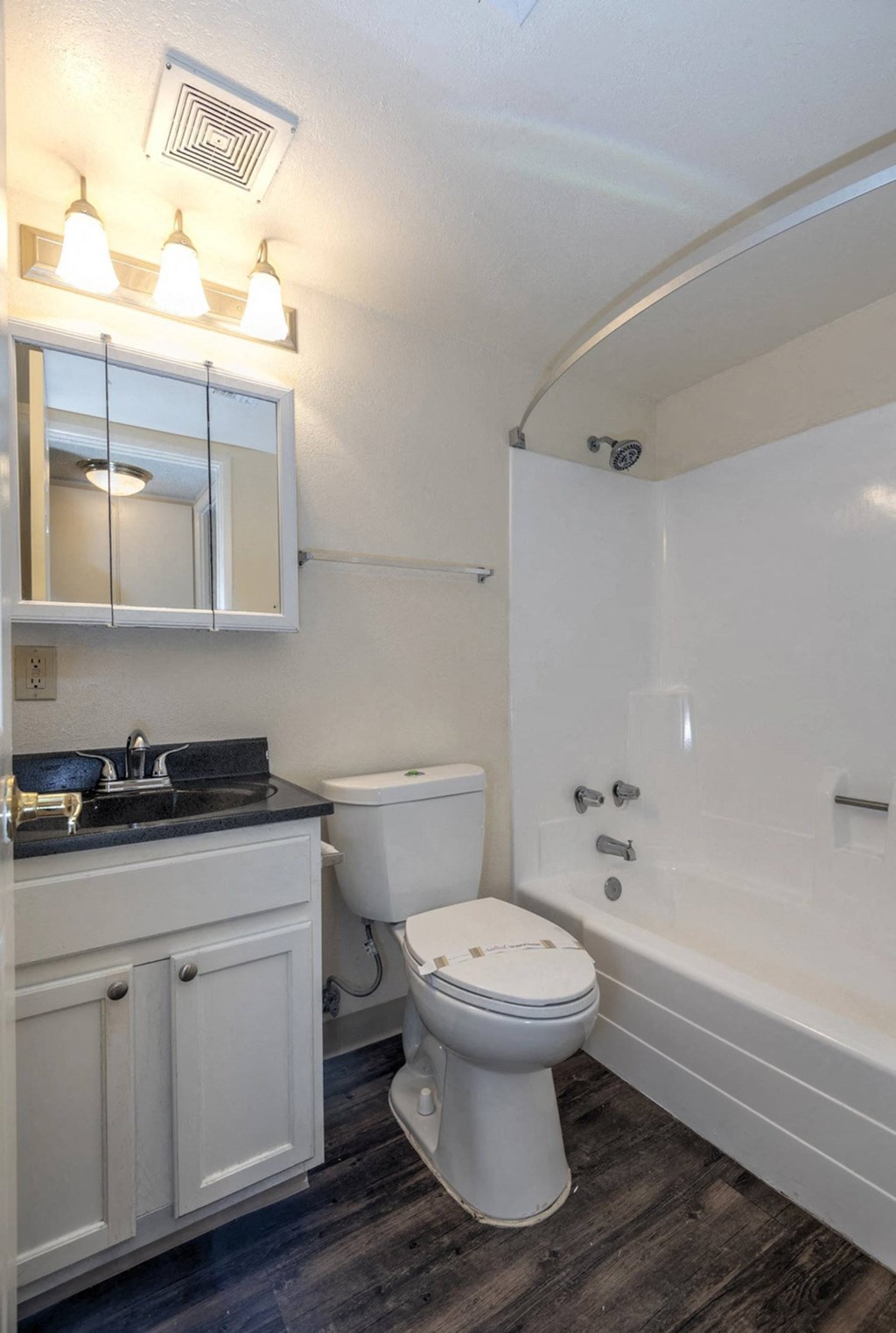 a bathroom with a toilet sink and bathtub