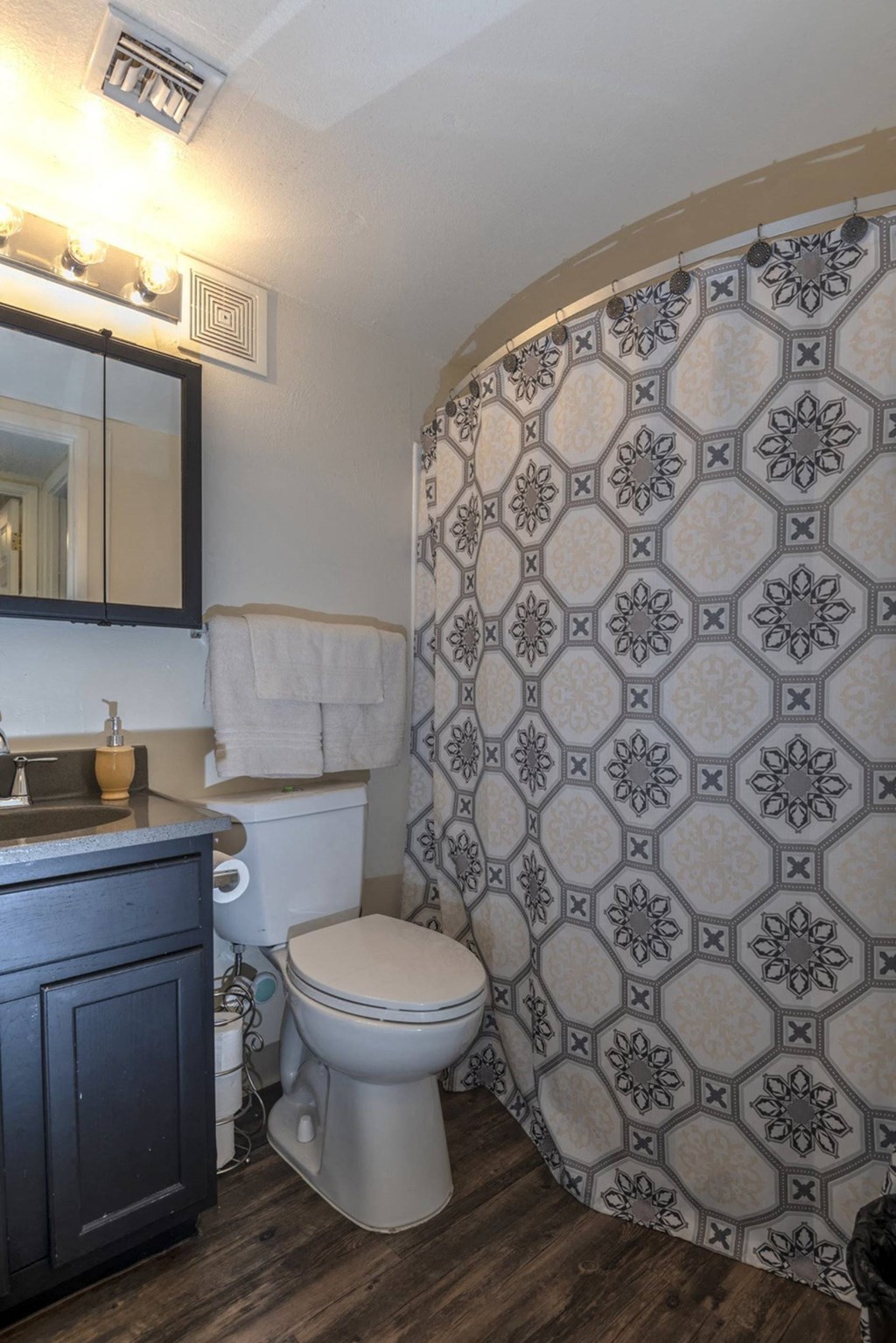 a bathroom with a toilet sink and shower