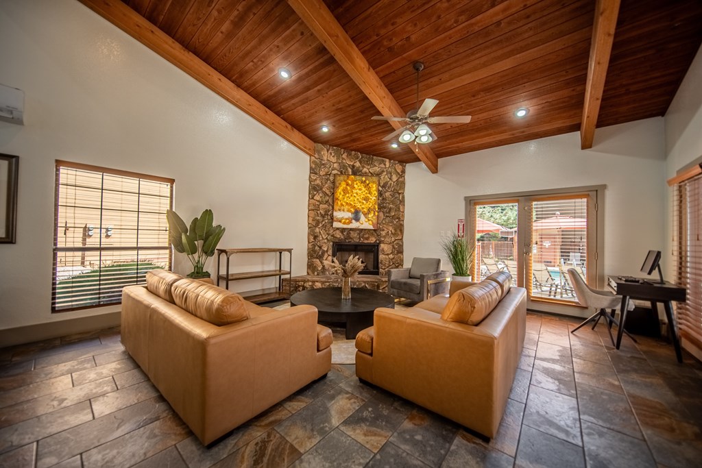 A living room with a fireplace and two couches.
