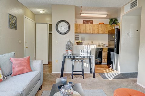 A living room with a grey couch and a coffee table.