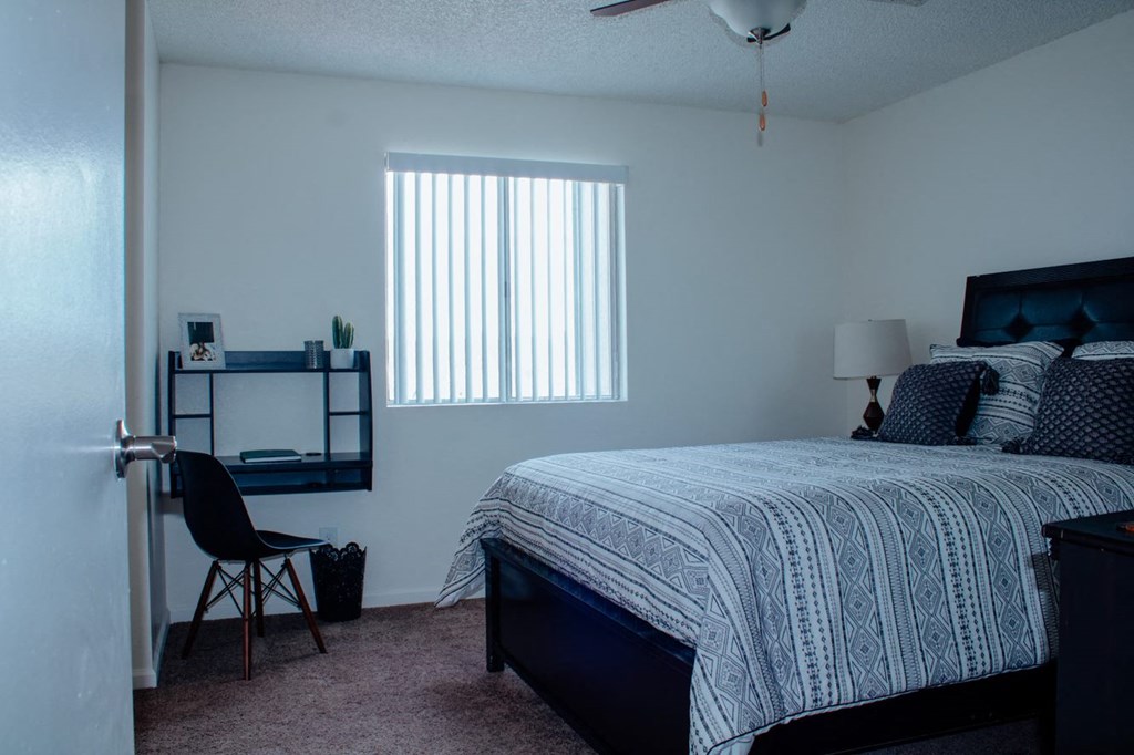 a bedroom with a bed and a desk