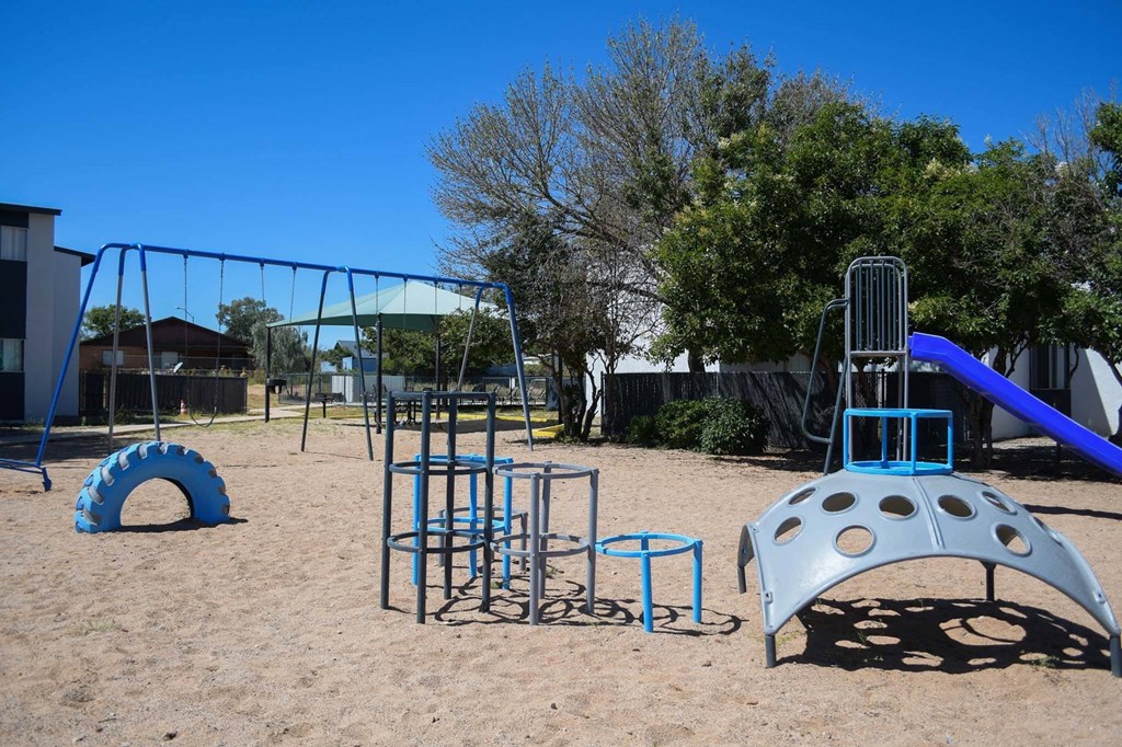 a playground with a slide and climbing equipment