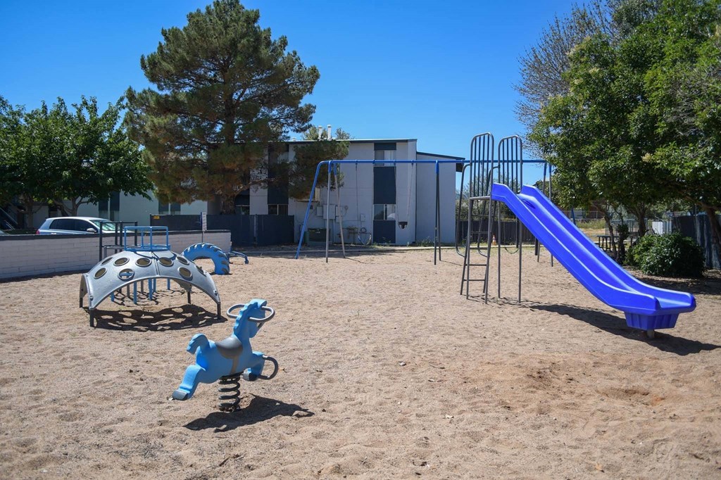 a playground with a slide and a rocking horse