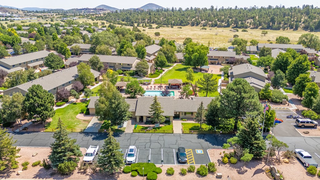 A large building complex with a parking lot in front.