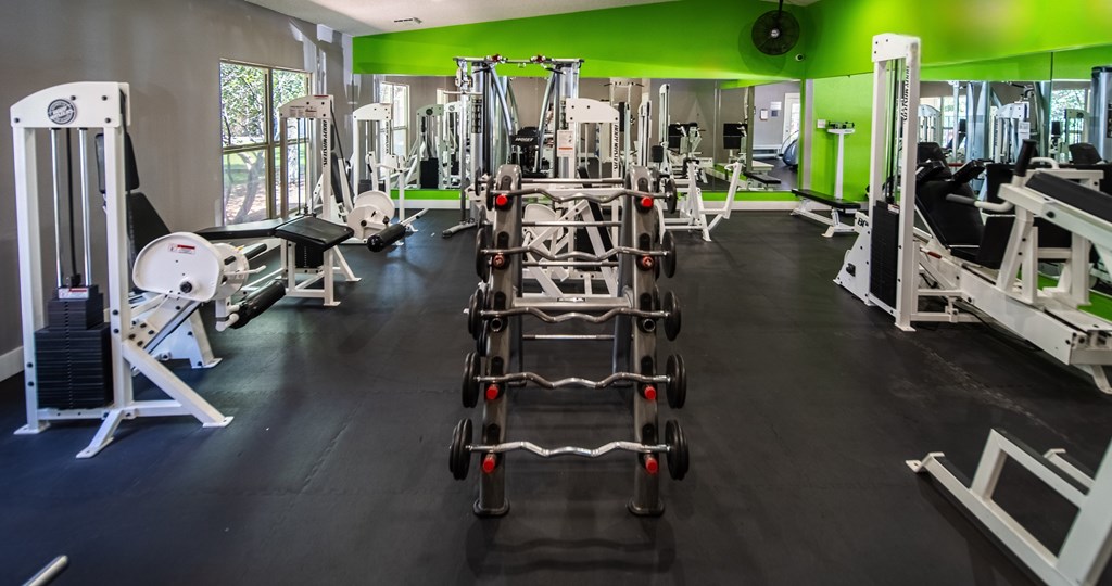 A gym with a variety of equipment including a leg press machine.