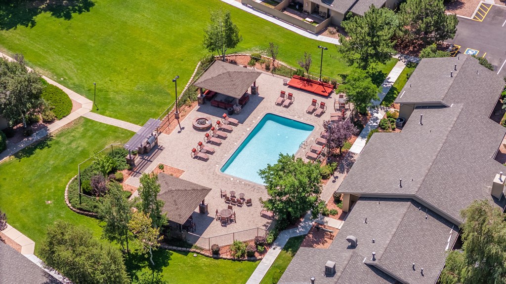 A backyard with a pool and a gazebo.