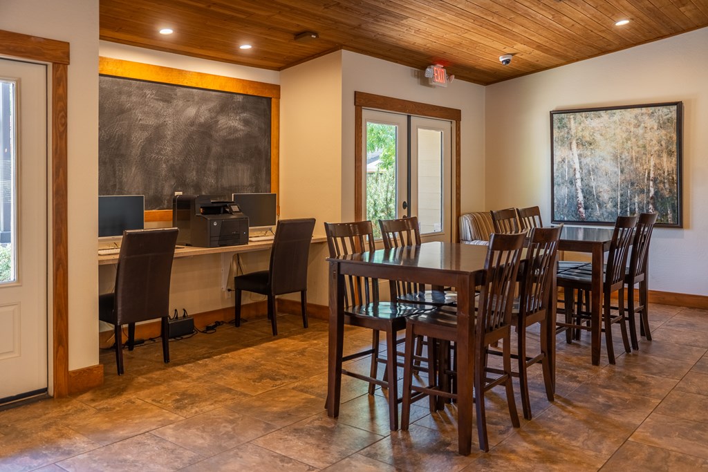 A dining room with a wooden table and chairs.